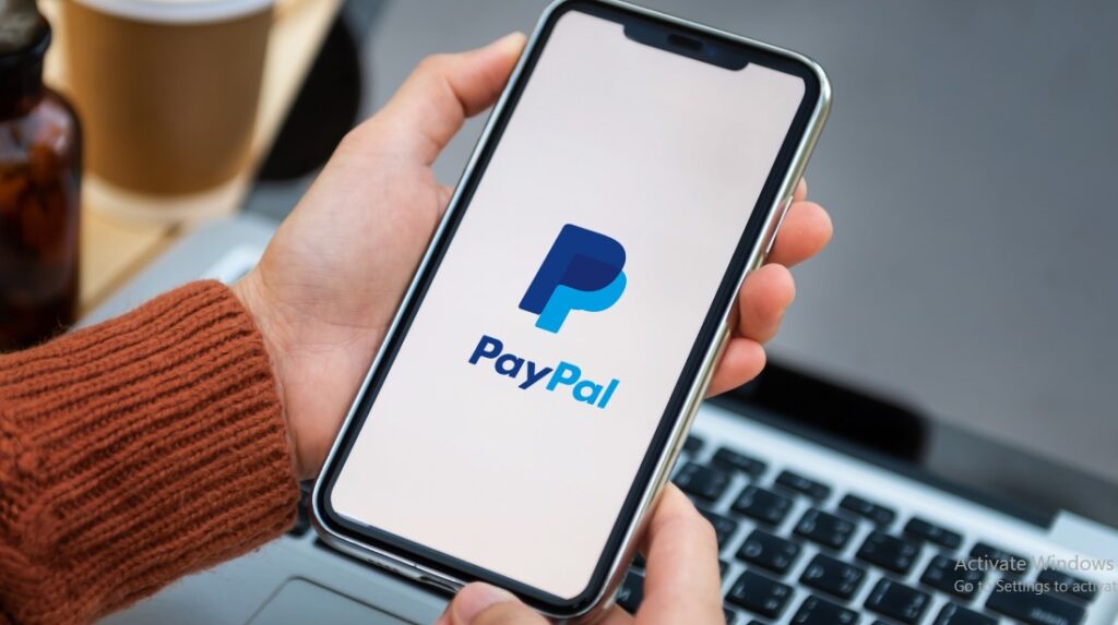 Paypal on a Mobile Phone held by a female hand